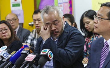 Alex Tan (centre) reads out a gratitude letter by his son to the teachers at the Think school. Photo: Dickson Lee