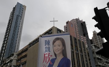 A poster for pro-establishment candidate Chan Hoi-yan hangs on a street corner after she won the West Kowloon by-election in Hong Kong. Photo: AP