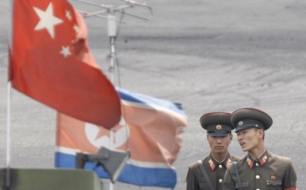 North Korean soldiers stand guard behind national flags of China and North Korea near the North Korean town of Sinuiju, opposite the Chinese border city of Dandong. Photo: Reuters North Korean soldiers stand guard behind national flags of China and North Korea near the North Korean town of Sinuiju, opposite the Chinese border city of Dandong. Photo: Reuters
