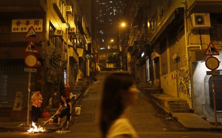 Two women burning hell money during the Hungry Ghost Festival in Hong Kong. Photo: Vincent Yu Two women burning hell money during the Hungry Ghost Festival in Hong Kong. Photo: Vincent Yu