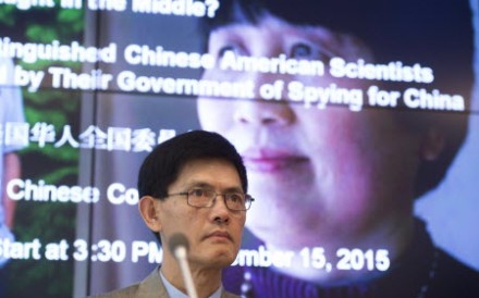 Xiaoxing Xi, chair of the Physics Department at Temple University, speaks alongside a photo of Sherry Chen right, a US federal government worker, about the dropped charges. Photo: AFP
