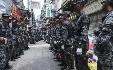 PLA soldiers line the streets of Macau to launch clean-up operations. Photo: Edward Wong