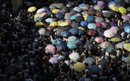 Protesters use umbrellas as shelter from the sun at a demonstration against the jailing of pro-democracy activists. Photo: AP