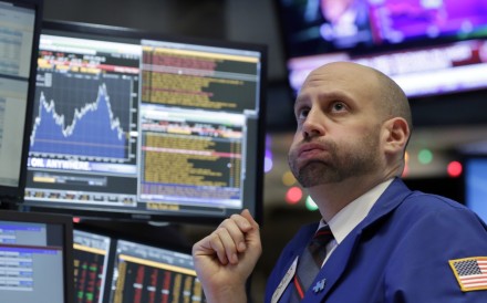 Specialist Meric Greenbaum works at his post on the floor of the New York Stock Exchange, Friday, December 11, 2015. Photo: AP