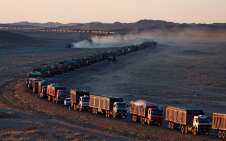 Thousands of heavy-duty trucks loaded with coal make their way along the sole road through the Gobi desert in Mongolia to the Chinese border. Photo: Reuters