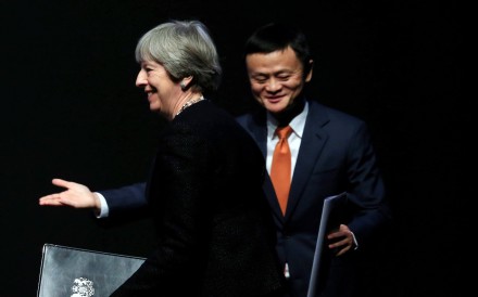 Alibaba's founder and Executive Chairman Jack Ma gestures as British Prime Minister Theresa May walks to the stage to deliver a speech at the China-UK business forum in Shanghai, China February 2, 2018. REUTERS/Stringer NO RESALES. NO ARCHIVES.