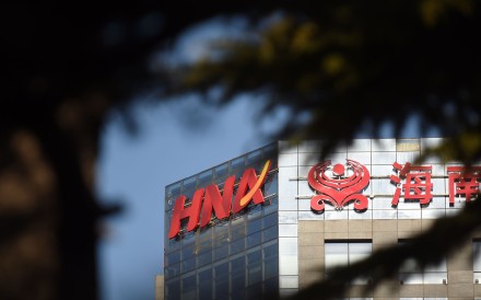 The HNA logo is seen on a building in Beijing on February 18, 2016. Chinese conglomerate HNA will buy US technology distributor Ingram Micro for 6.0 billion USD, a statement said, the latest firm to snap up a foreign entity as part of Beijing's outward investment drive. Photo: AFP