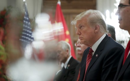 Donald Trump appeared defensive at the start of the dinner with Xi JInping. Photo: AP