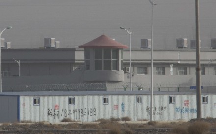 A guard tower and barbed wire fences around an internment facility in Xinjiang. Photo: AP A guard tower and barbed wire fences around an internment facility in Xinjiang. Photo: AP