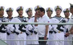 Filipino President Rodrigo Duterte salutes Chinese Navy personnel as he tours a Chinese Naval ship during a visit in Davao city. Photo: EPA