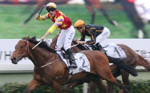 Tommy Berry salutes as Designs On Rome beats Able Friend in the 2014 Hong Kong Derby. Photos: Kenneth Chan