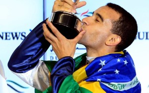 Joao Moreira is draped in the Brazilian flag after winning on World Cup night aboard Sterling City. Photo: EPA