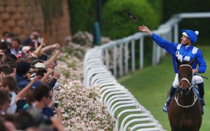 Hugh Bowman throws his goggles into the crowd after winning the Cox Plate with Winx. Photo: Michael Dodge/Getty Images