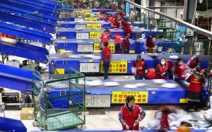 Workers sort packages after the Singles' Day shopping festival at a delivery company in Hengyang, China, on November 12. Photo: AFP