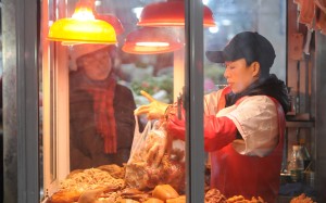 A vendor packs food for a customer at a market in Jiujiang, Jiangxi province. China’s headline consumer price rises are only 2.5 per cent up from a year ago, while core inflation remains subdued at 1.8 per cent. From an inflation standpoint, there is nothing stopping another major monetary push. Photo: Reuters