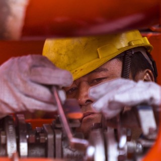 A worker at the Yangzijiang Shipbuilding Group's shipyard in Jiangyin on October 18. China\'s economy grew slower than expected, at 6.5 per cent year-on-year, in the quarter ending in September, with domestic demand falling even as export data remained strong. Photo: EPA-EFE