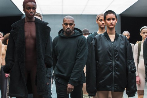 Kanye West walks past models after presenting his Fall/Winter 2015 partnership line with Adidas at New York Fashion Week in 2015.