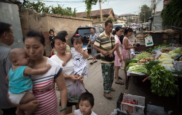 Residents buying vegetables at an outdoor stall in the village. Photo: AFP Residents buying vegetables at an outdoor stall in the village. Photo: AFP