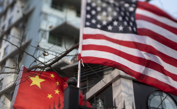 The Chinese and US national flags hang on a fence at an international school in Beijing. Technology and geopolitics are entwined, and it is conceivable that Washington does not consider its own strategic interests are advanced by helping Beijing towards its own technology goals. Photo: AFP  