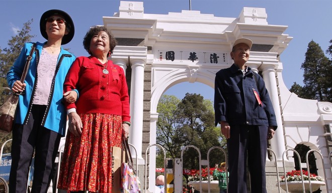 Alumni take photos at Tsinghua University in Beijing.