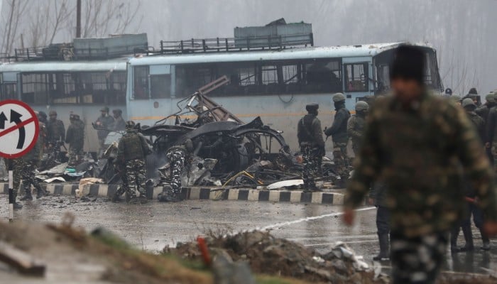 Indian security officers inspect the site of the blast in Jammu and Kashmir’s Pulwama district on Thursday. Photo: EPA-EFE