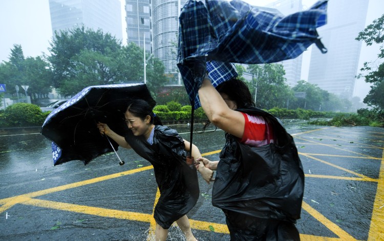 Two residents brave the wind in Shenzhen's Nanshan district on Sunday. Photo: Xinhua