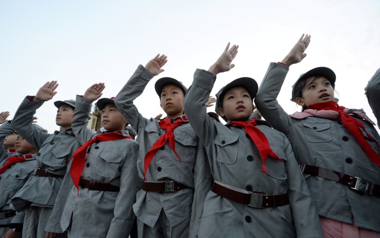 Primary school students dressed in replica red army uniforms and the Young Pioneer scarf at a ceremony in Beijing. Photo: Reuters