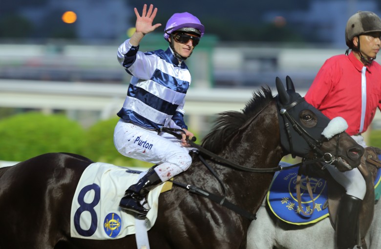 Reigning champion Zac Purton salutes the crowd after bringing up his fifth win of the day on Packing Llaregyb in the final race. Photo: Kenneth Chan