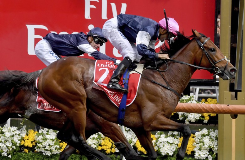 Rekindling and jockey Corey Brown win the Melbourne Cup, watched by Ben Melham on board second-placed Johannes Vermeer at Flemington. Photo: AP
