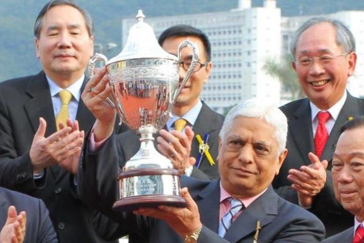 Manu Melwani, aka Sam The Tailor, lifts the trophy after Green Zone's win. Photo: Kenneth Chan