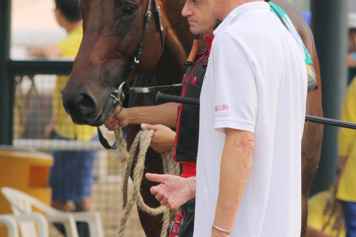 Trainer John Moore and jockey Douglas Whyte talk tactics ahead of Flagship Shine's gallop at Sha Tin. Photo: Kenneth Chan 