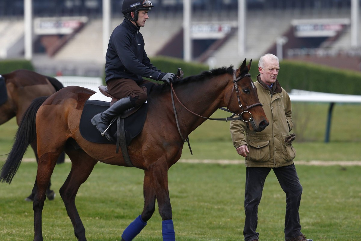 Irish trainer Willie Mullins with Hurricane Fly after a workout at Cheltenham on Monday. Hurricane Fly seeks a third Champion Hurdle win. Photo: Reuters