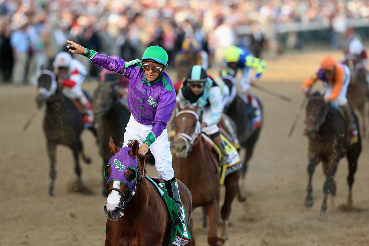 Jockey Victor Espinoza celebrates atop of California Chrome after crossing the finish line to win the 140th running of the Kentucky Derby in Louisville, Kentucky. Photo: AFP