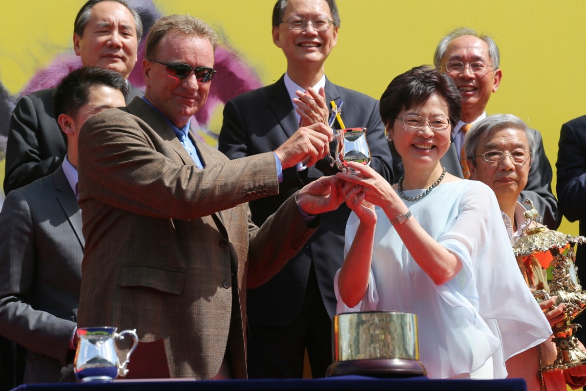 Chief Secretary Carrie Lam Cheng Yuet-ngor congratulates trainer Tony Millard on Golden Harvest's success.  