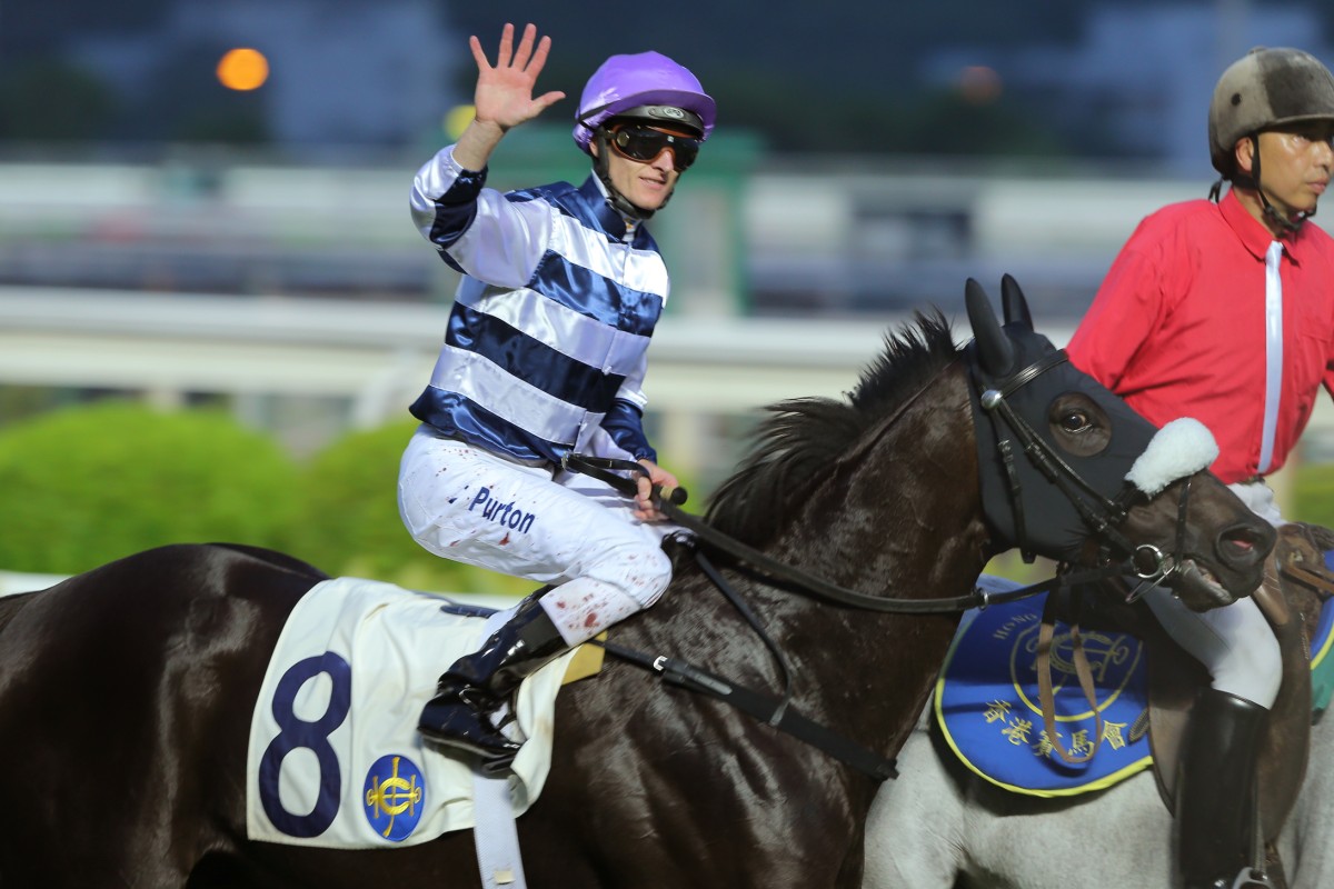 Reigning champion Zac Purton salutes the crowd after bringing up his fifth win of the day on Packing Llaregyb in the final race. Photo: Kenneth Chan