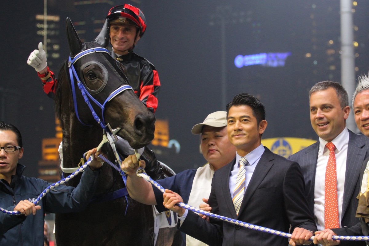 Aaron Kwok and Caspar Fownes pose for photos with Calling With Love after his last win in January. Photo: Kenneth Chan