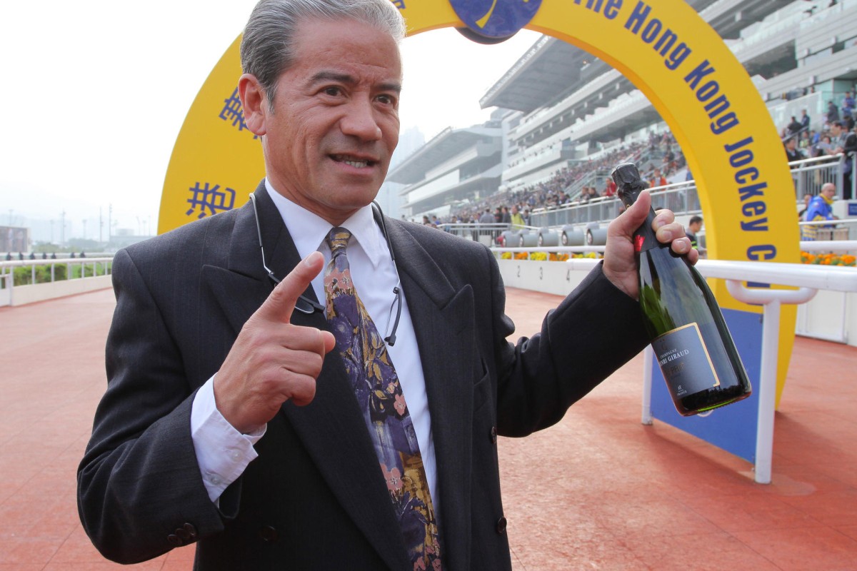 Tony Cruz shows off his bottle of champagne as he celebrates his 1,000th win as a trainer. Photos: Kenneth Chan