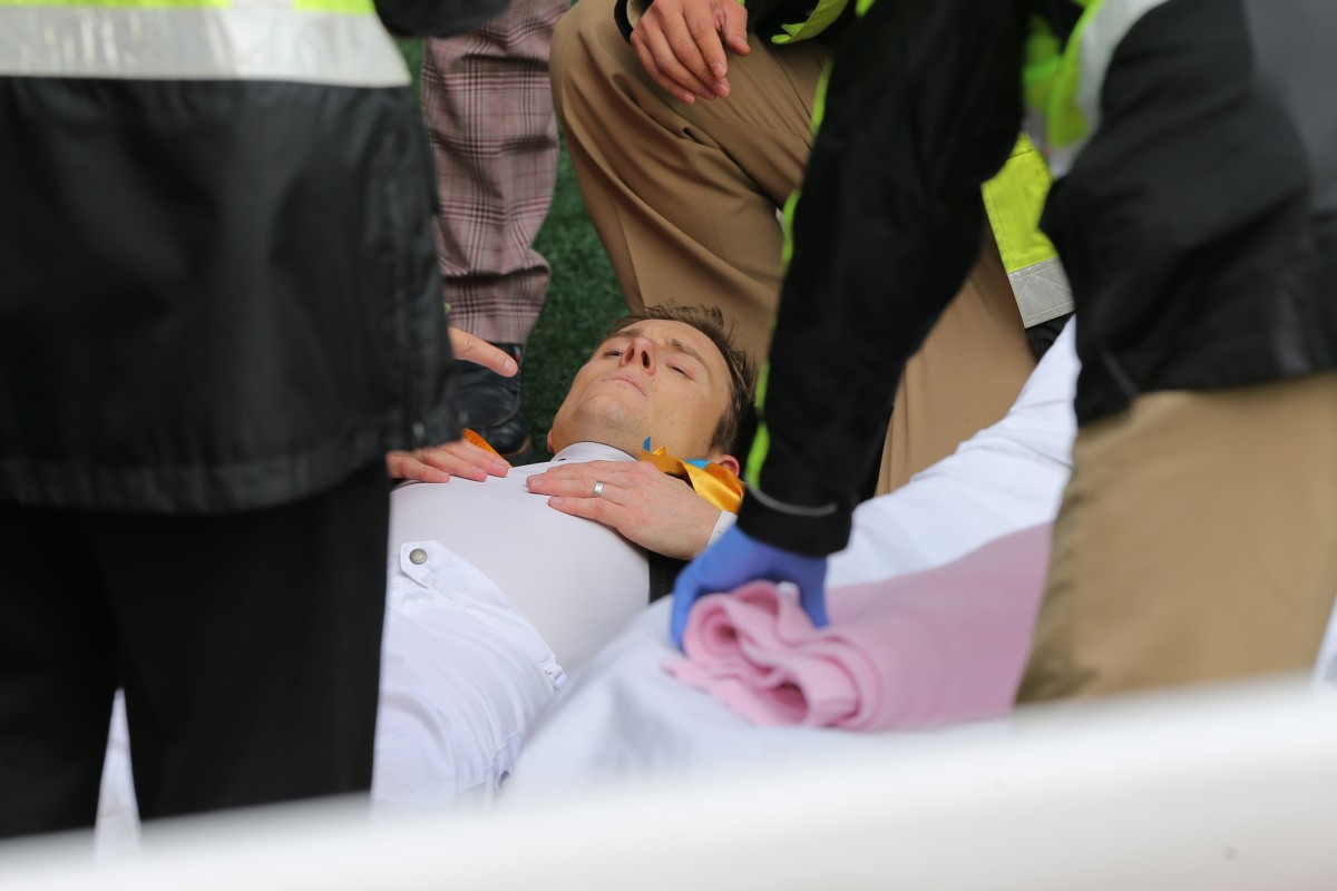 Zac Purton is attended to by medical staff after collapsing at Sha Tin on Sunday. Photo: Kenneth Chan 