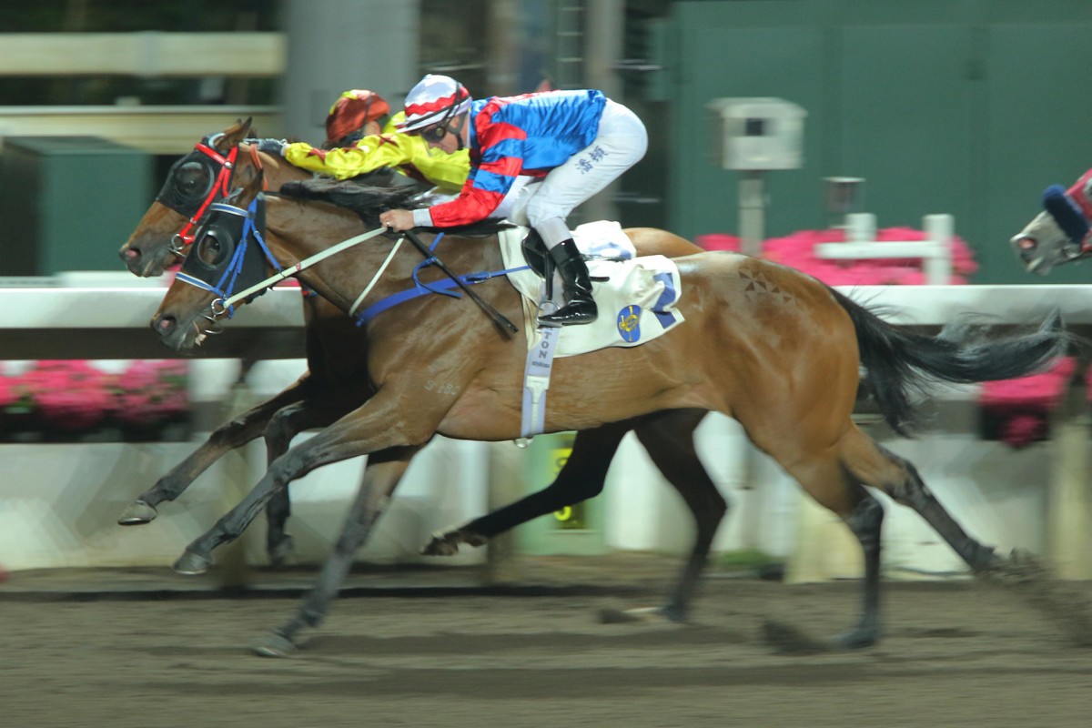 Zac Purton drives home Gun Pit, the second leg of a riding treble, in record course time at Sha Tin on Wednesday night. Photos: Kenneth Chan
