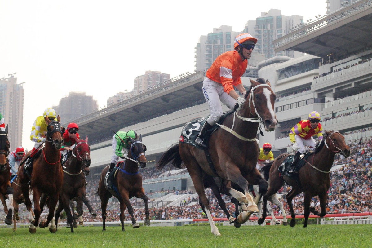 Neil Callan celebrates as Tony Cruz's Blazing Speed puts a space on his rivals to win the Audemars Piguet QE II Cup, from a wall lining up for the minors. Photos: Kenneth Chan