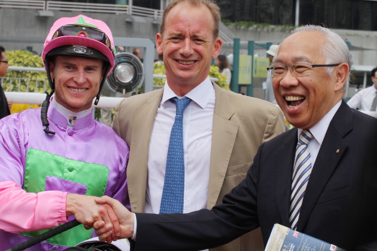 Zac Purton celebrates the win of Joyful Moments with trainer Richard Gibson and owner Raymond Chow Wai-kam.
