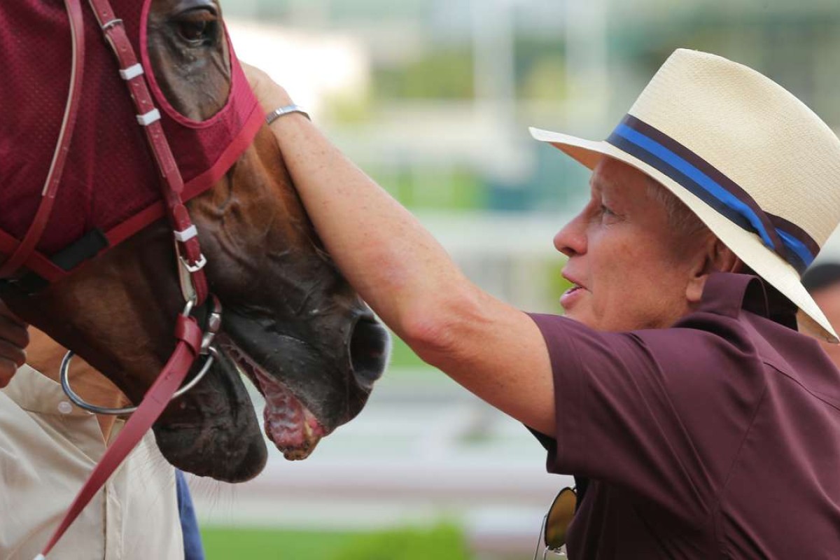 John Moore gives Rapper Dragon a pat after his win in the Lion Rock Trophy at Sha Tin in May. Photo: Kenneth Chan