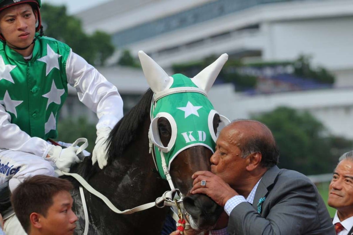 Kerm Din gives boom horse Pakistan Star a kiss, watched by jockey Matthew Chadwick and trainer Tony Cruz. Photo: Kenneth Chan