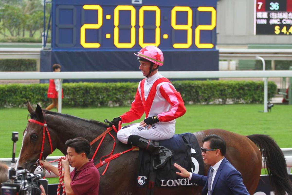 Nash Rawiller and Dennis Yip return to the winner’s circle with Secret Weapon, who ran a slick time in the Group Two Jockey Club Cup. Photos: Kenneth Chan