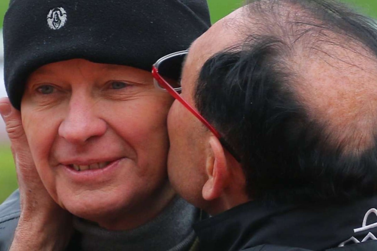 Gary Moore plants a kiss on his brother John’s cheek. Photos: Kenneth Chan