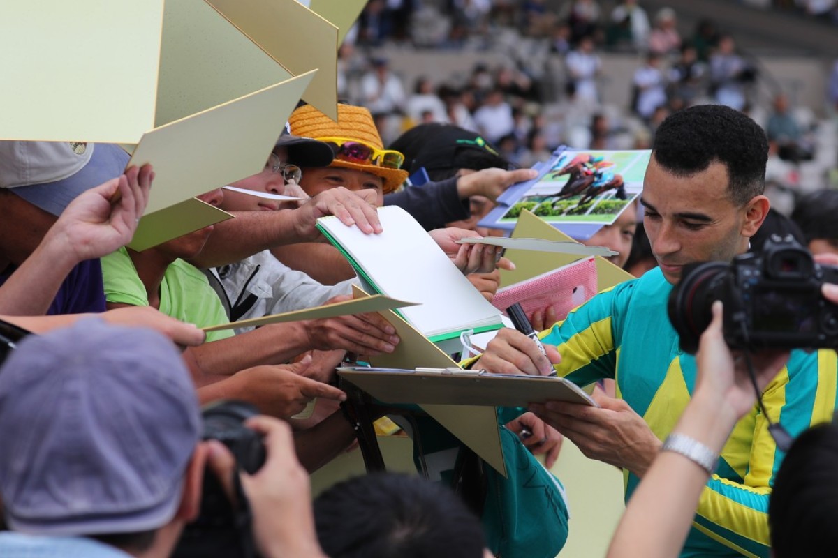 Joao Moreira is mobbed by Japanese fans wanting his autograph. Photos: Kenneth Chan