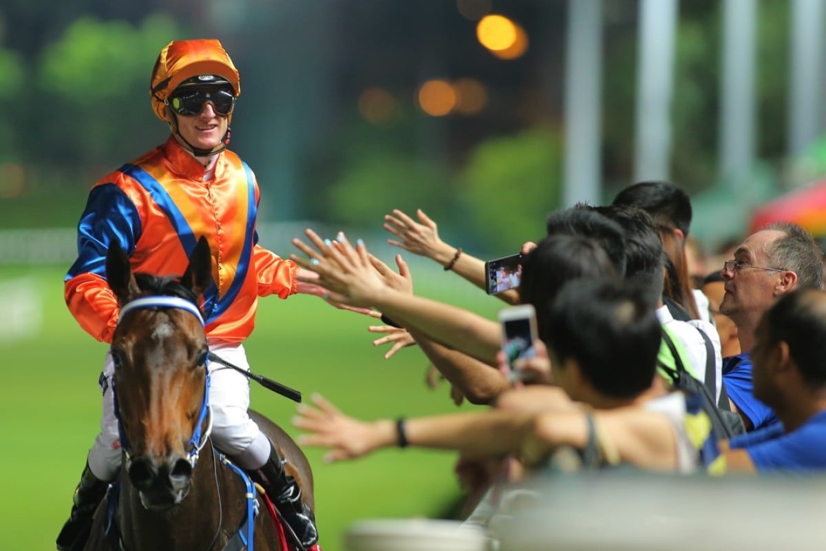 Zac Purton celebrates with fans after another Happy Valley win. Photos: Kenneth Chan.