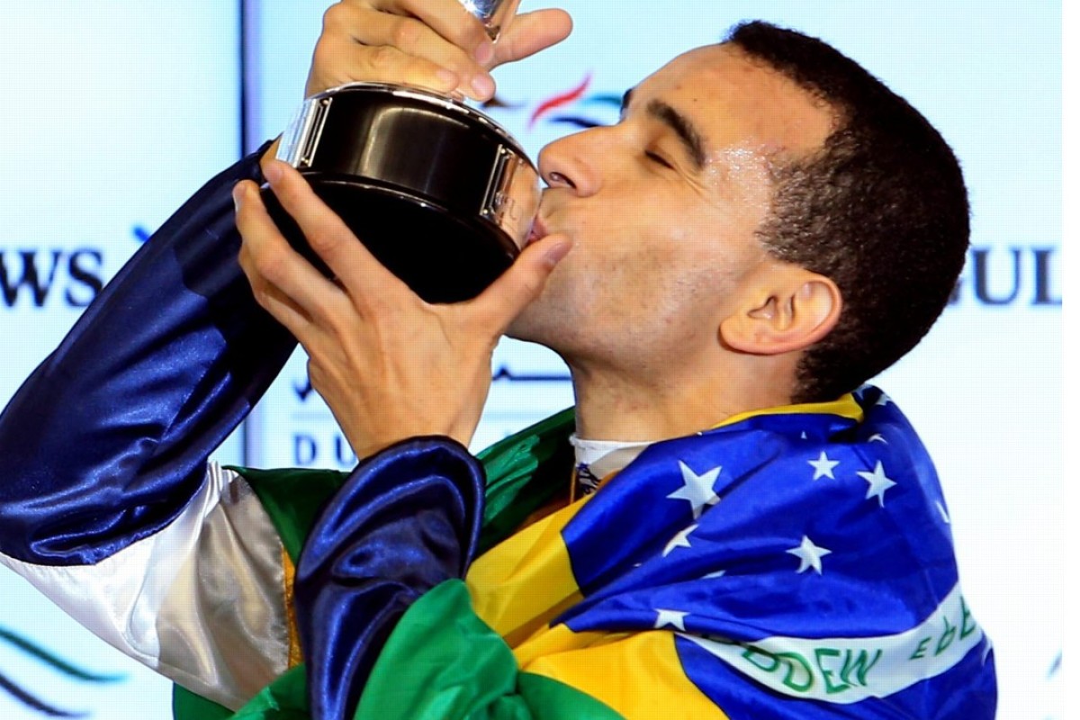 Joao Moreira is draped in the Brazilian flag after winning on World Cup night aboard Sterling City. Photo: EPA
