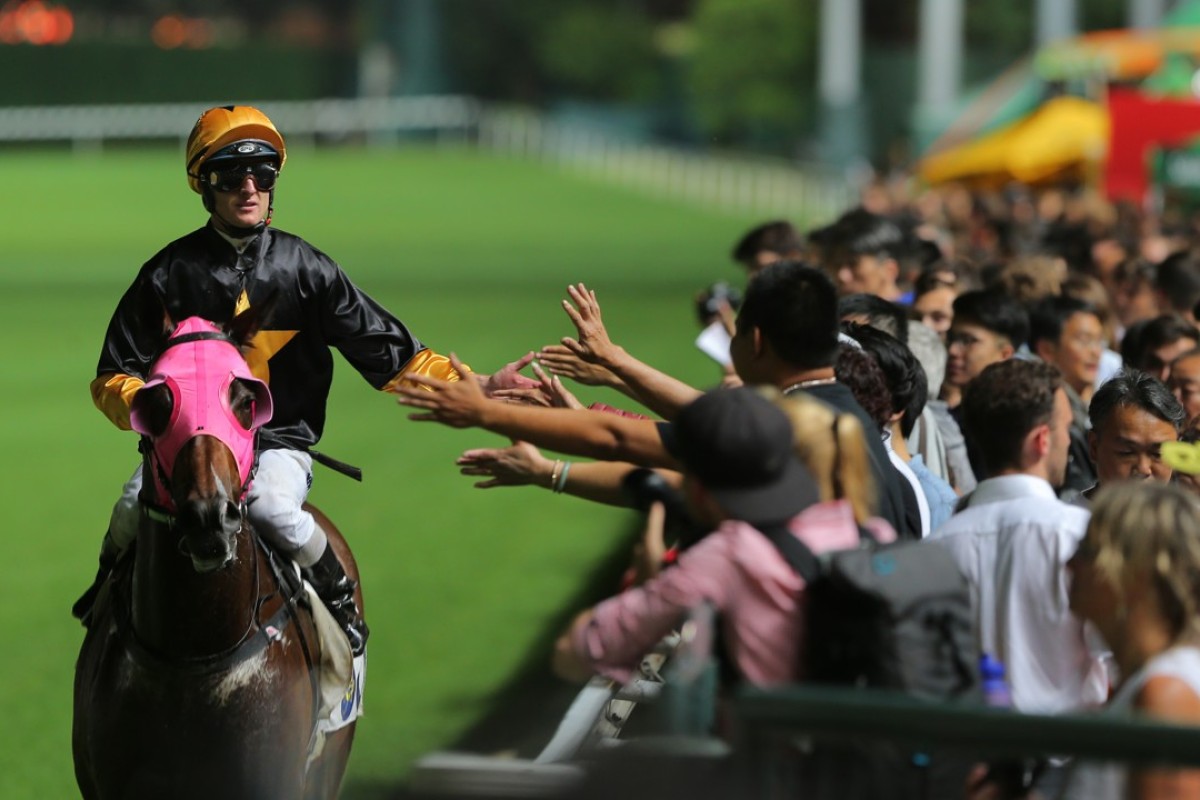 Zac Purton high fives fans after Top Score’s win at Happy Valley. Photos: Kenneth Chan.
