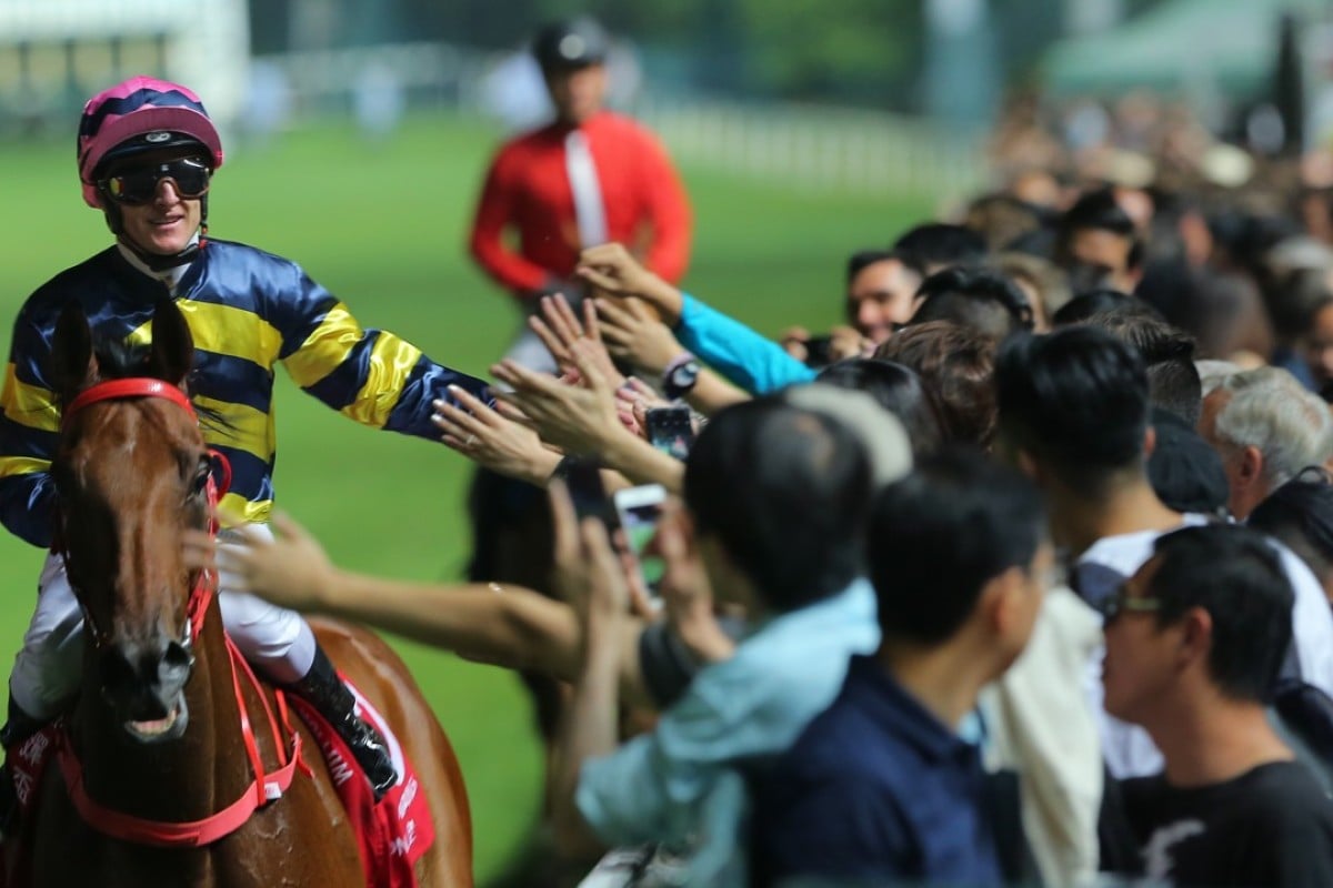 Zac Purton celebrates with the Happy Valley crowd after winning on Insayshable. Photos: Kenneth Chan